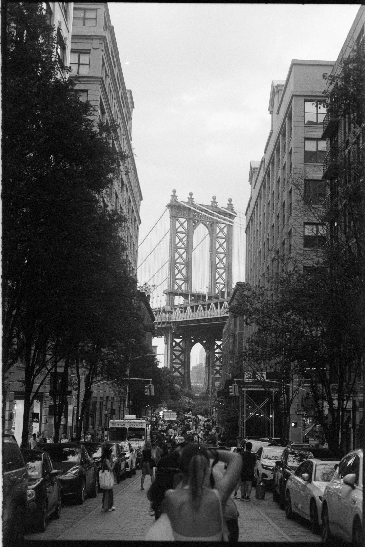 Black and white views of DUMBO Brooklyn streets with Manhattan Bridge in background and urban architecture.