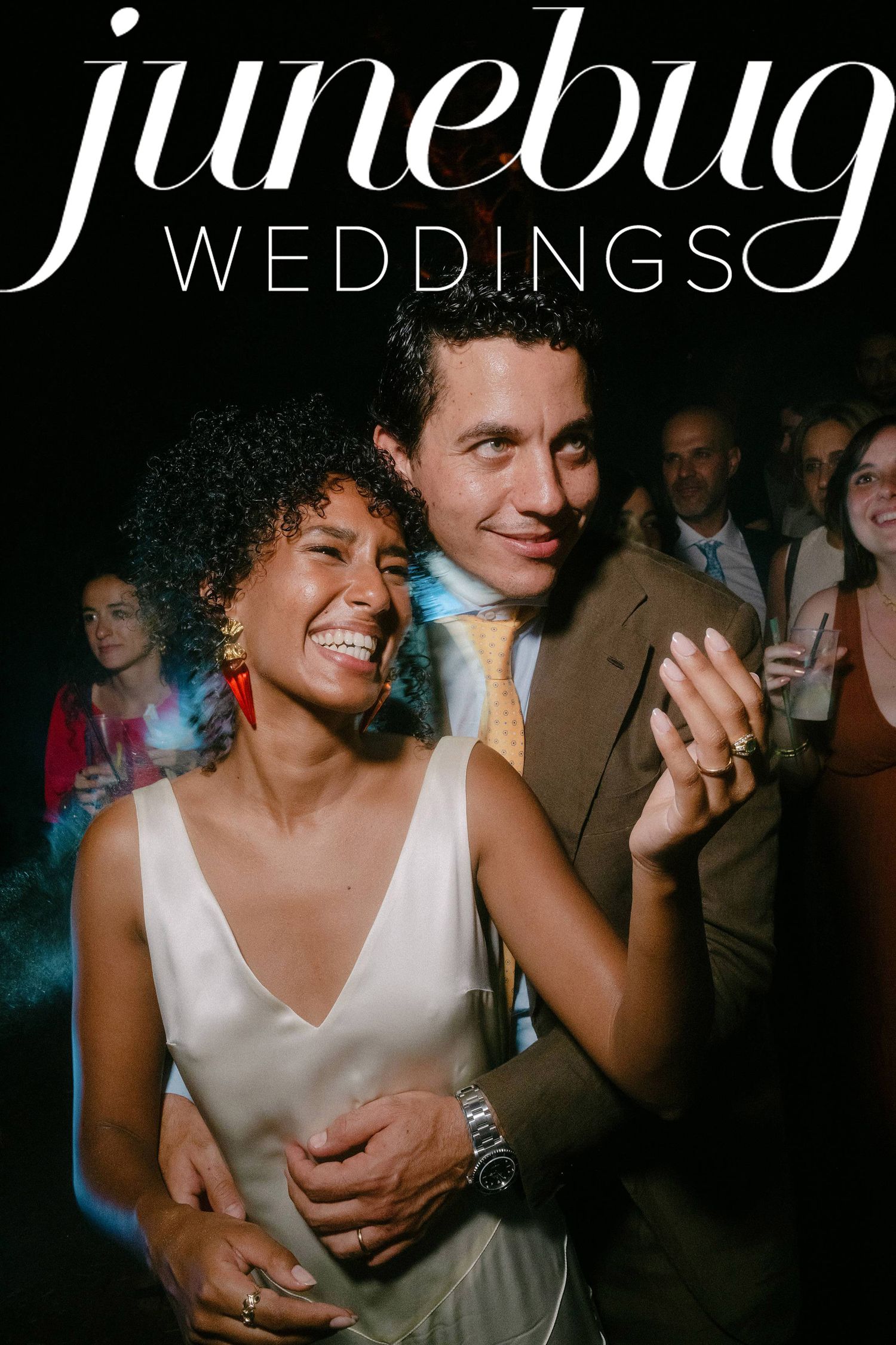 A couple dances together at a wedding reception, sharing joyful moments on the dance floor.