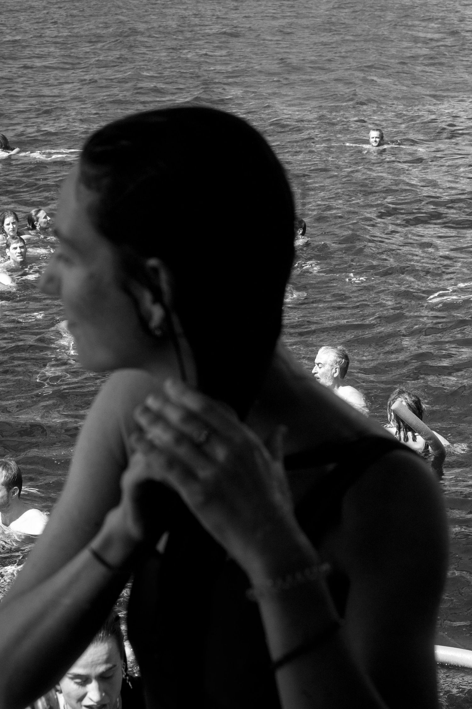 Black and white photo sequence showing a person diving into water from multiple angles.