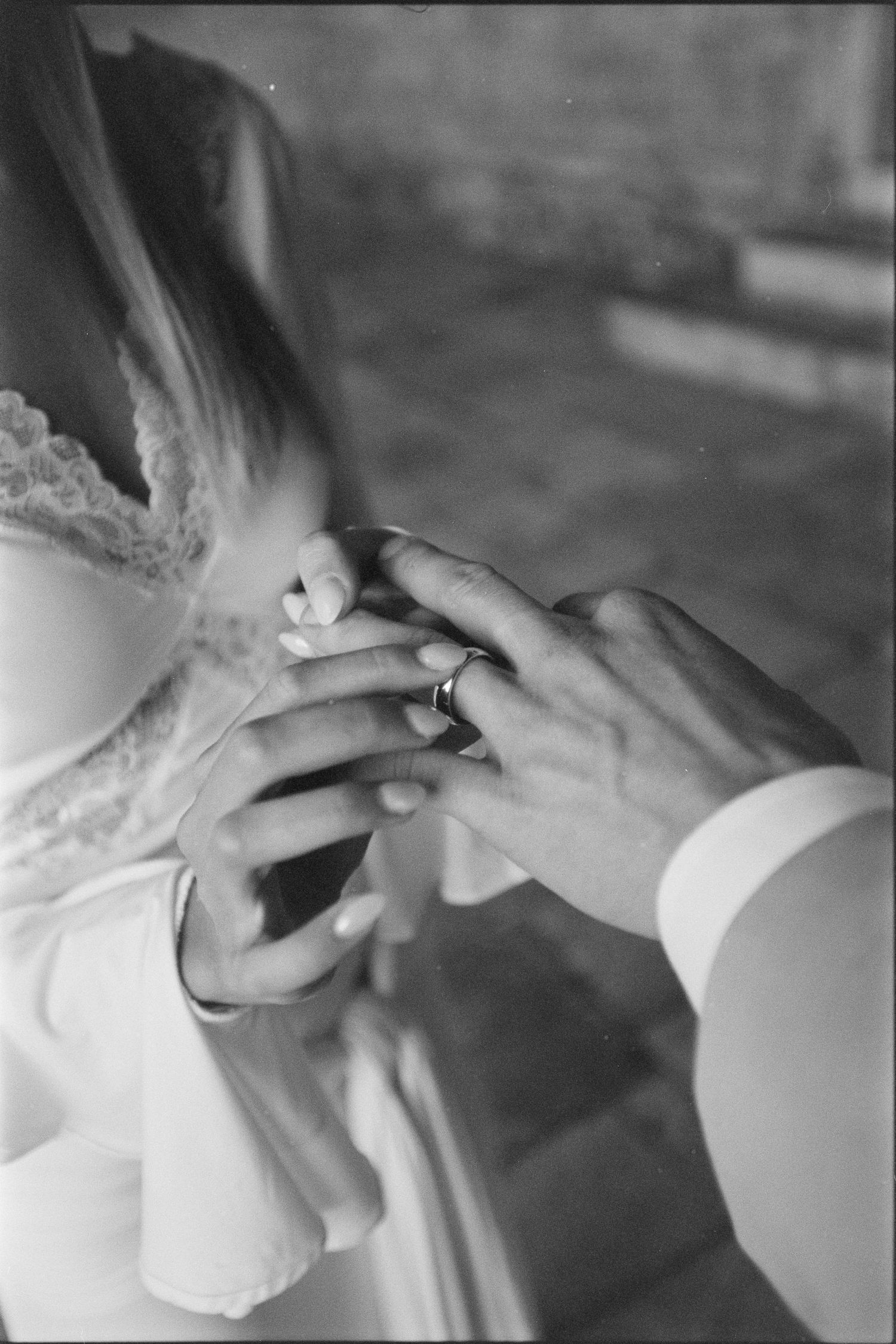 A black and white close-up photo sequence showing a wedding ring being placed on a finger during a ceremony.