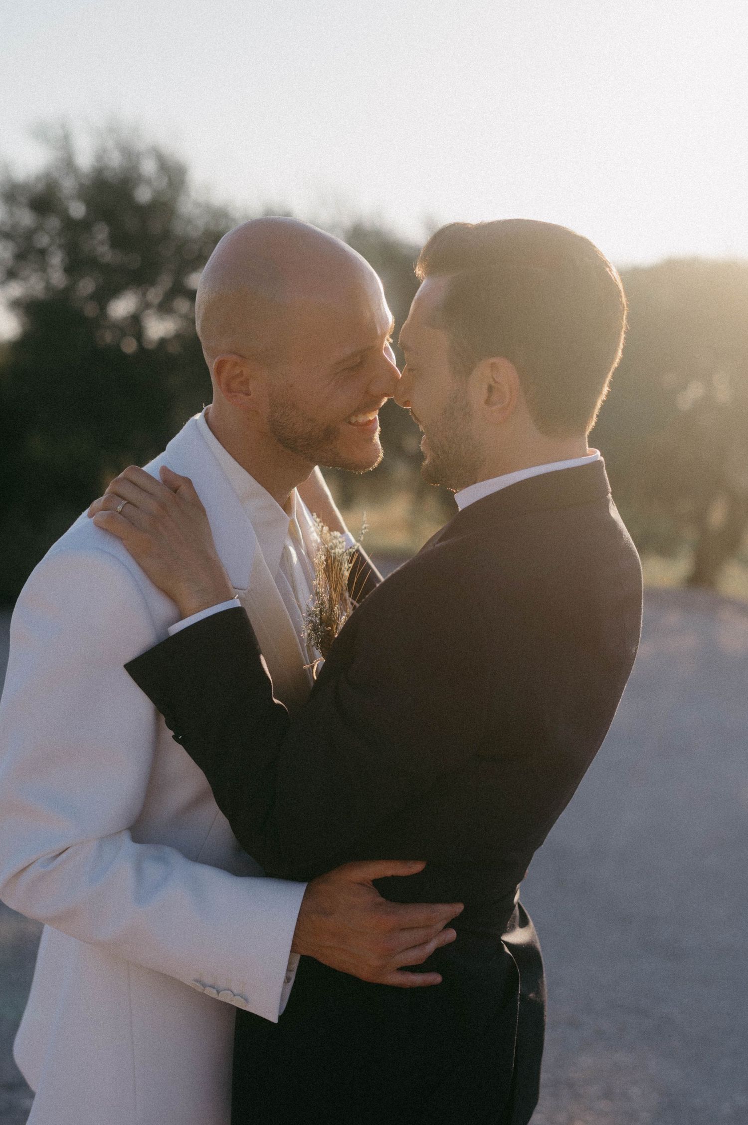 A romantic couple embraces outdoors during golden hour in a series of intimate candid moments.