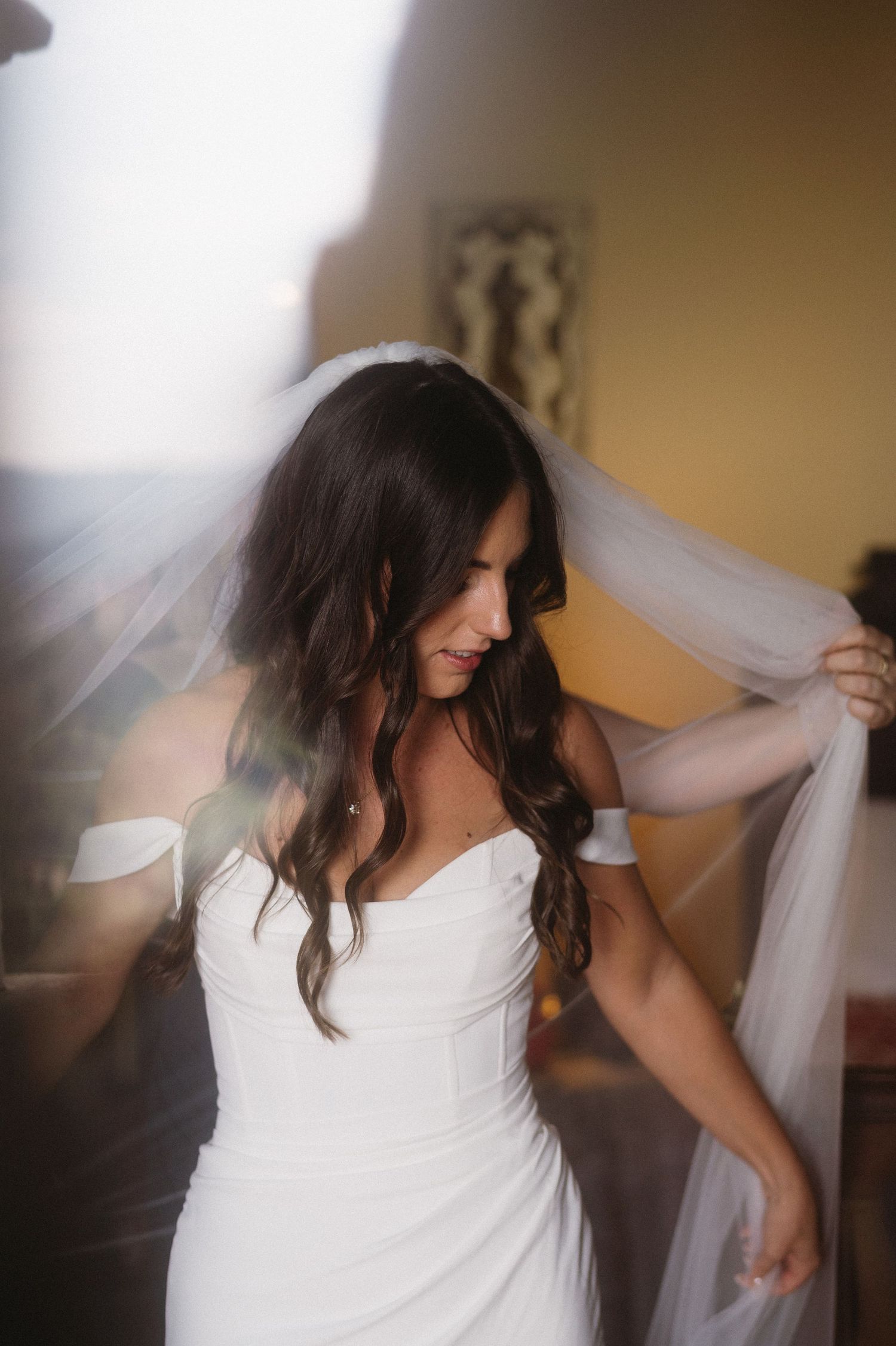 A bride in a white dress adjusts her flowing veil in a series of soft-focus candid moments.