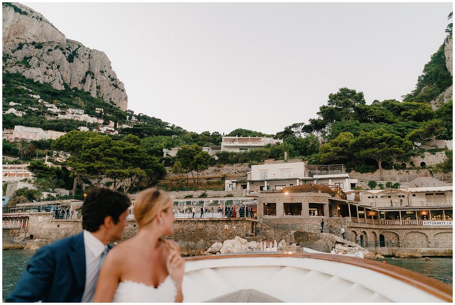 Scenic view of coastal buildings nestled into cliffs along the Mediterranean shore in Marina Grande, Capri, Italy.