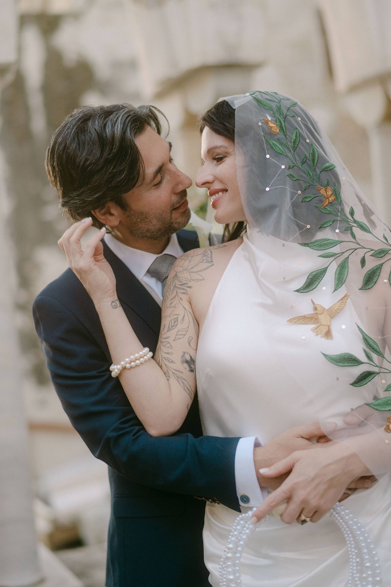 Romantic wedding couple embraces and shares intimate kisses in a series of four artistic portrait photographs.
