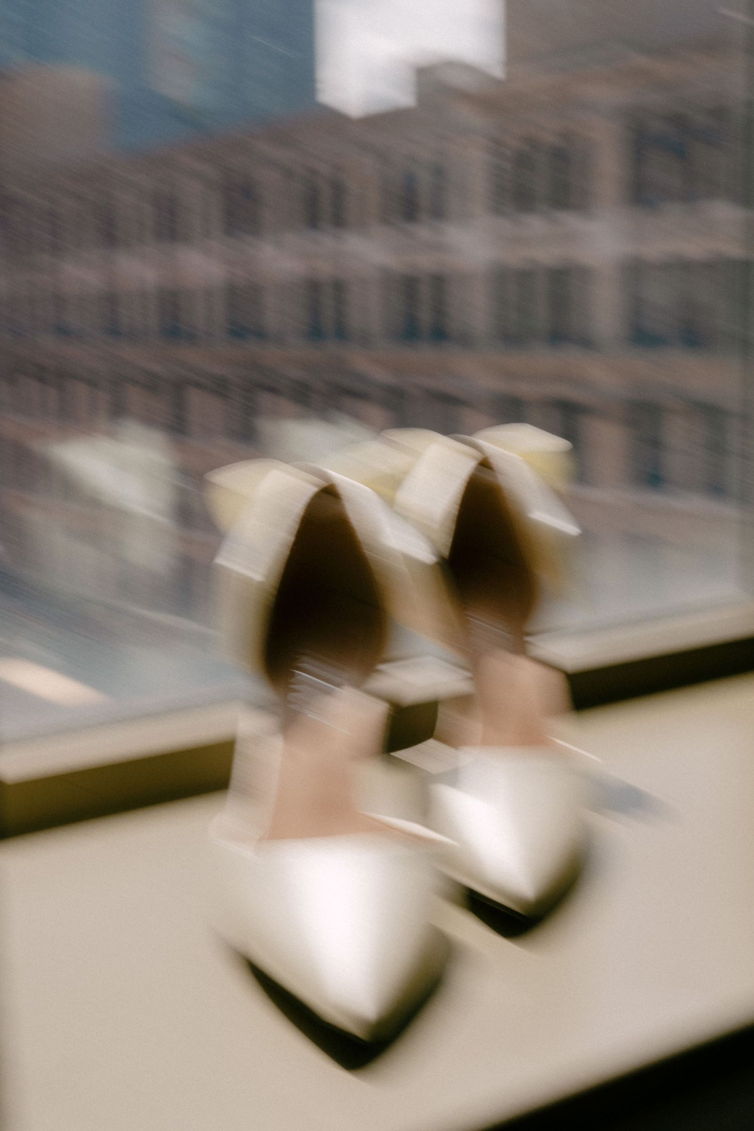 Blurred motion sequence showing abstract shapes on a light surface with a gradient effect.