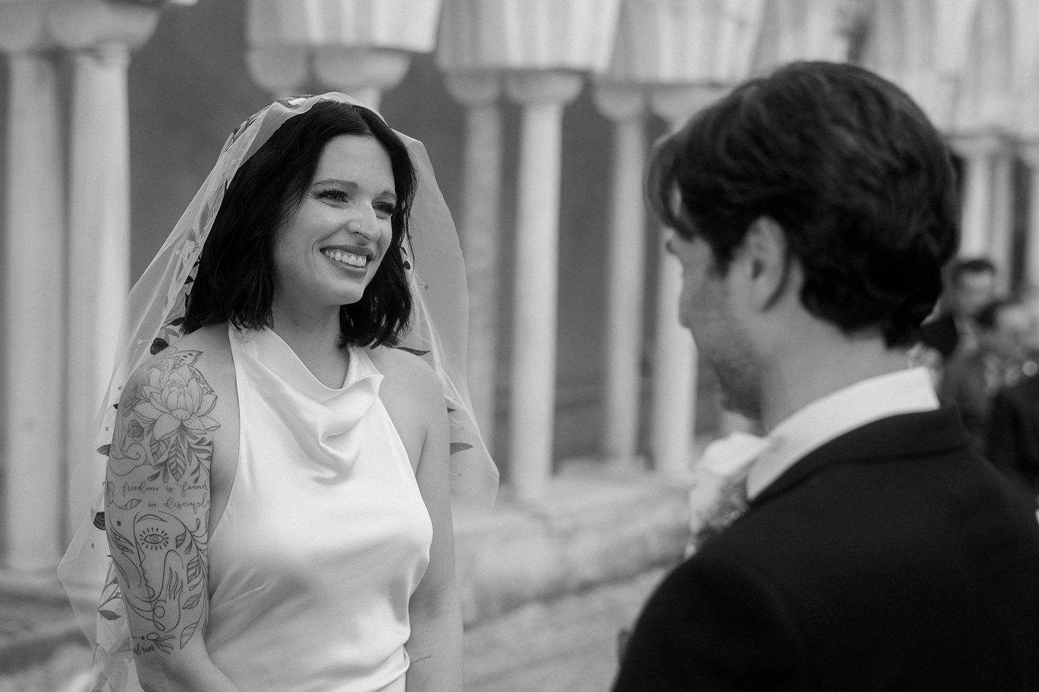 A series of black and white photos showing joyful moments from a wedding celebration.