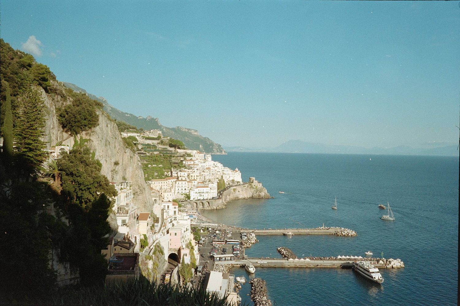 Panoramic view of colorful coastal buildings along cliffs overlooking the Mediterranean Sea in Cinque Terre, Italy.