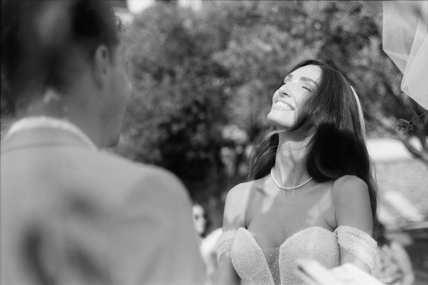 A collection of black and white photos showing people dancing and celebrating at a joyous outdoor event.