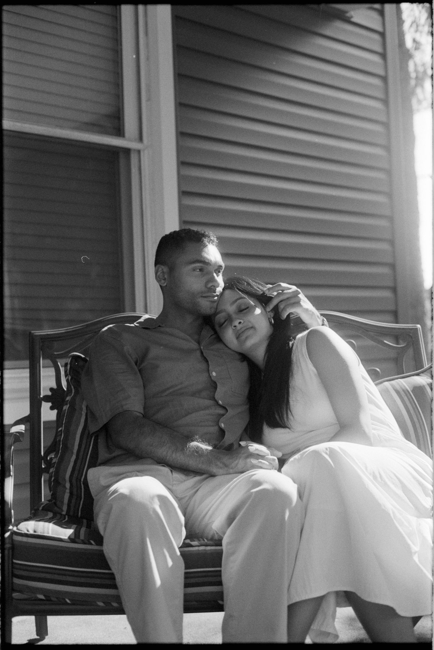 A black and white photo sequence shows a couple relaxing together on a porch bench in casual white clothing.