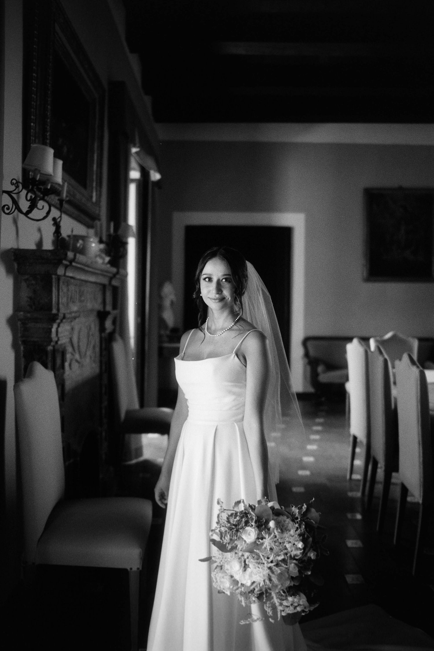 A series of black and white photos showing a wedding dress displayed in different angles with a bouquet.