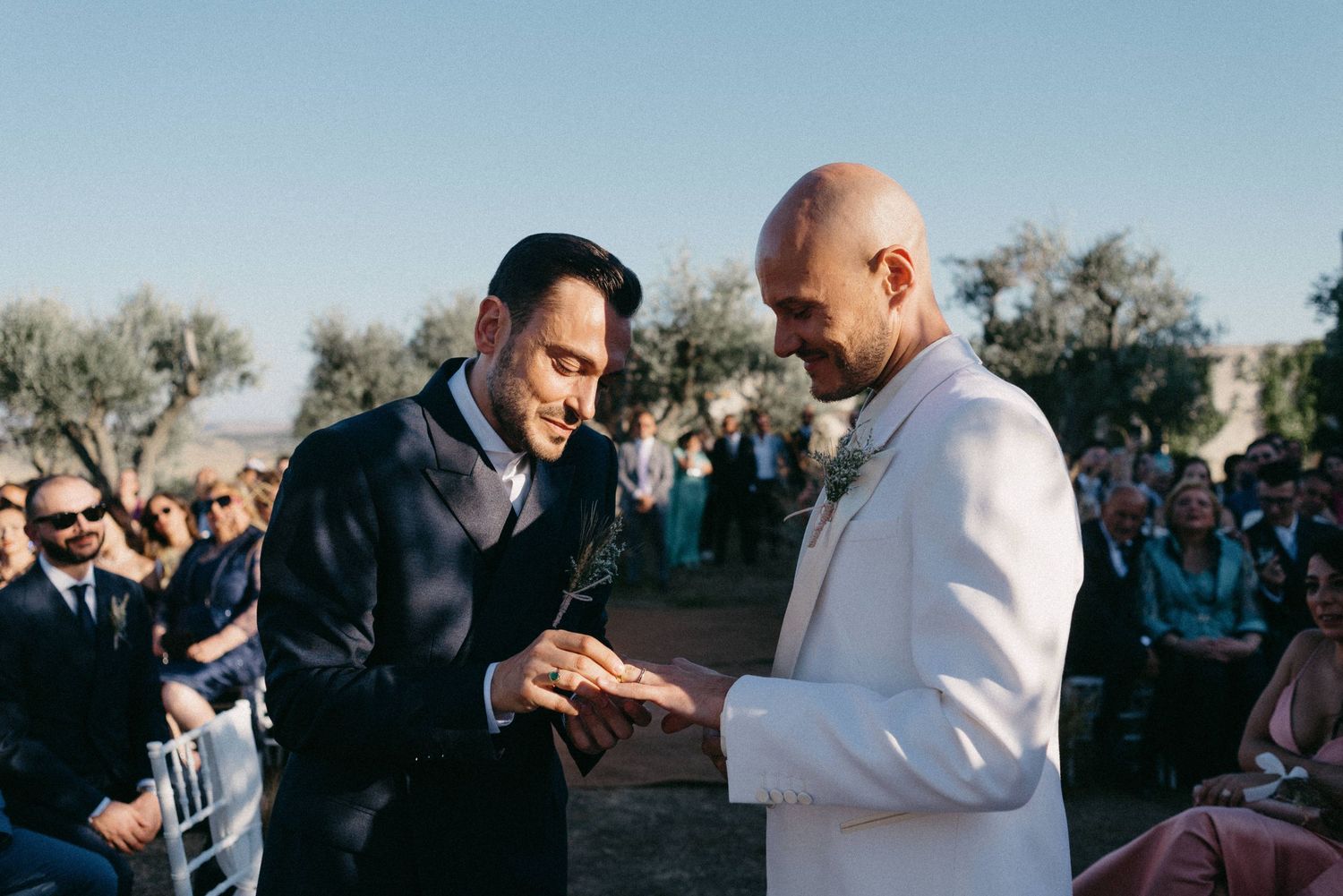 A sequence of photos showing two people embracing outdoors during a wedding ceremony.