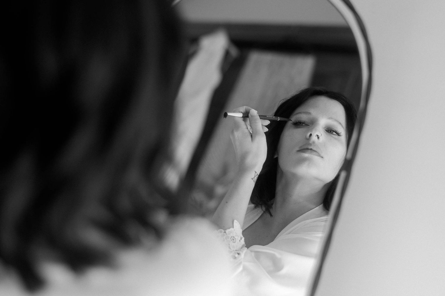 A black and white photo series showing a person's face from different angles in dramatic lighting.