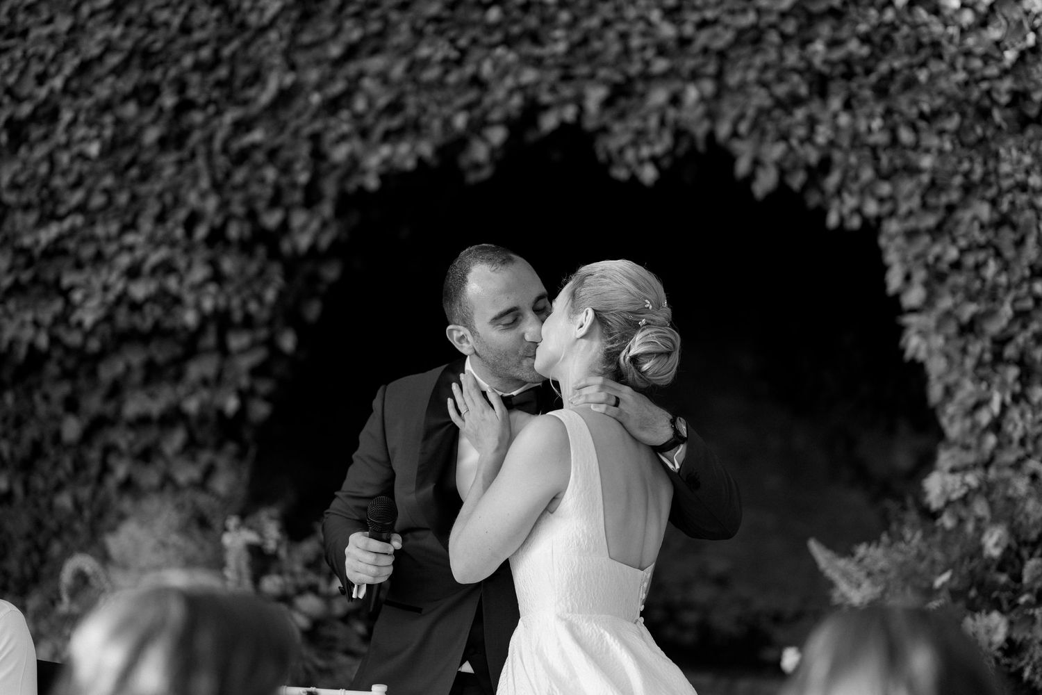 A series of romantic black and white wedding photos showing intimate moments between a couple during their celebration.