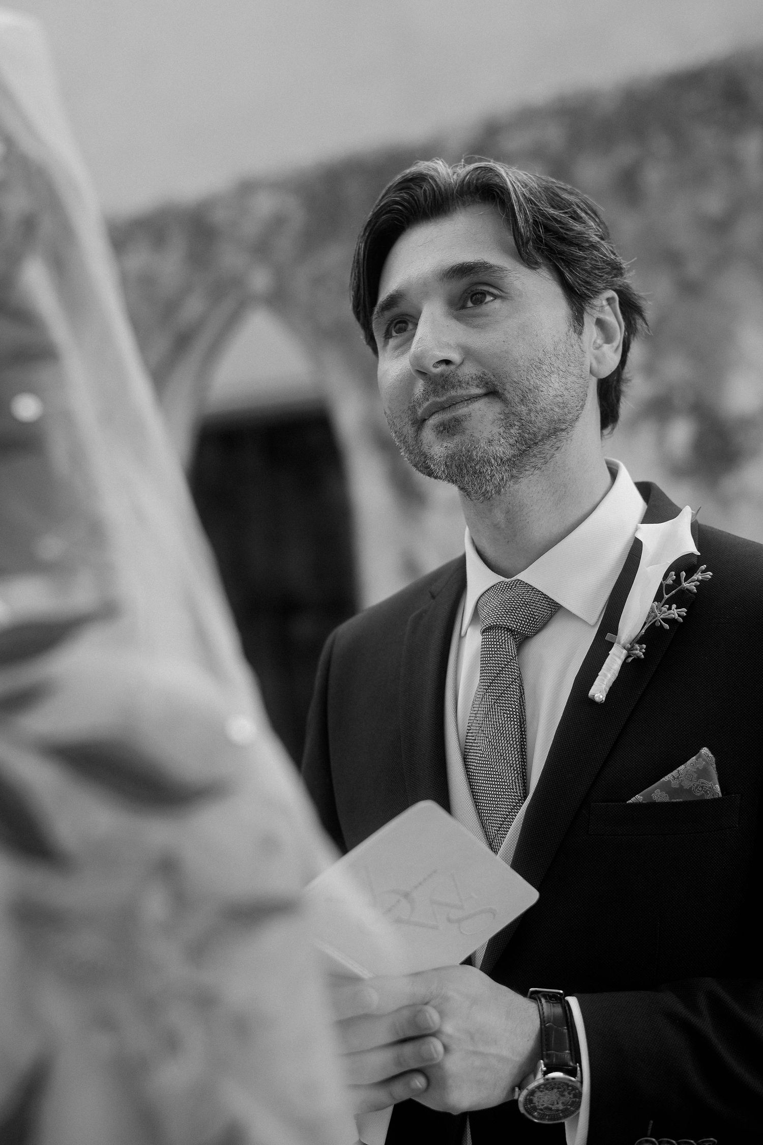 Black and white photo sequence showing a person in a suit adjusting their tie in a candid moment.