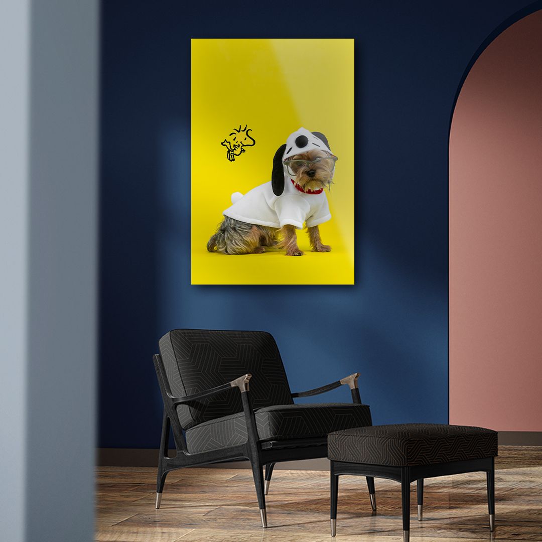 Yellow canvas wall art featuring a cute dog in a white costume, displayed in a modern blue room with black chair.