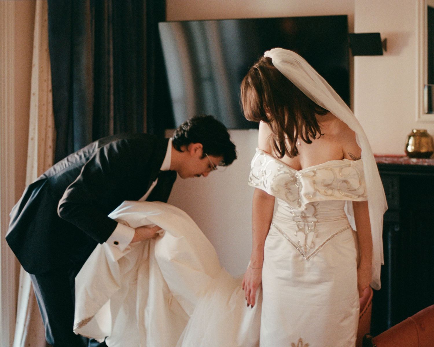 Sequence showing details of an elegant white wedding dress with flowing fabric.