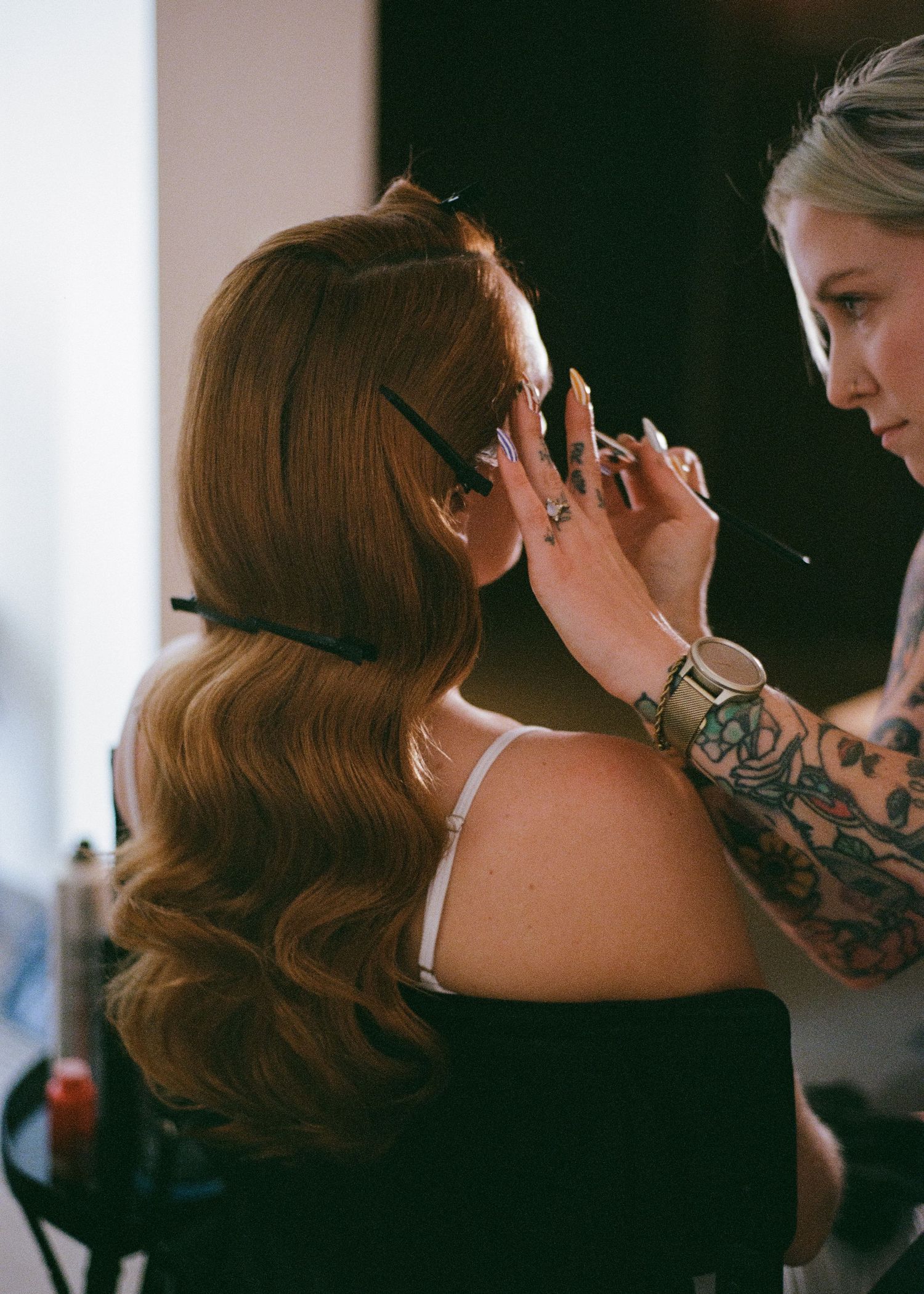 Close-up shots of bridal makeup application and hair styling preparations in natural light.