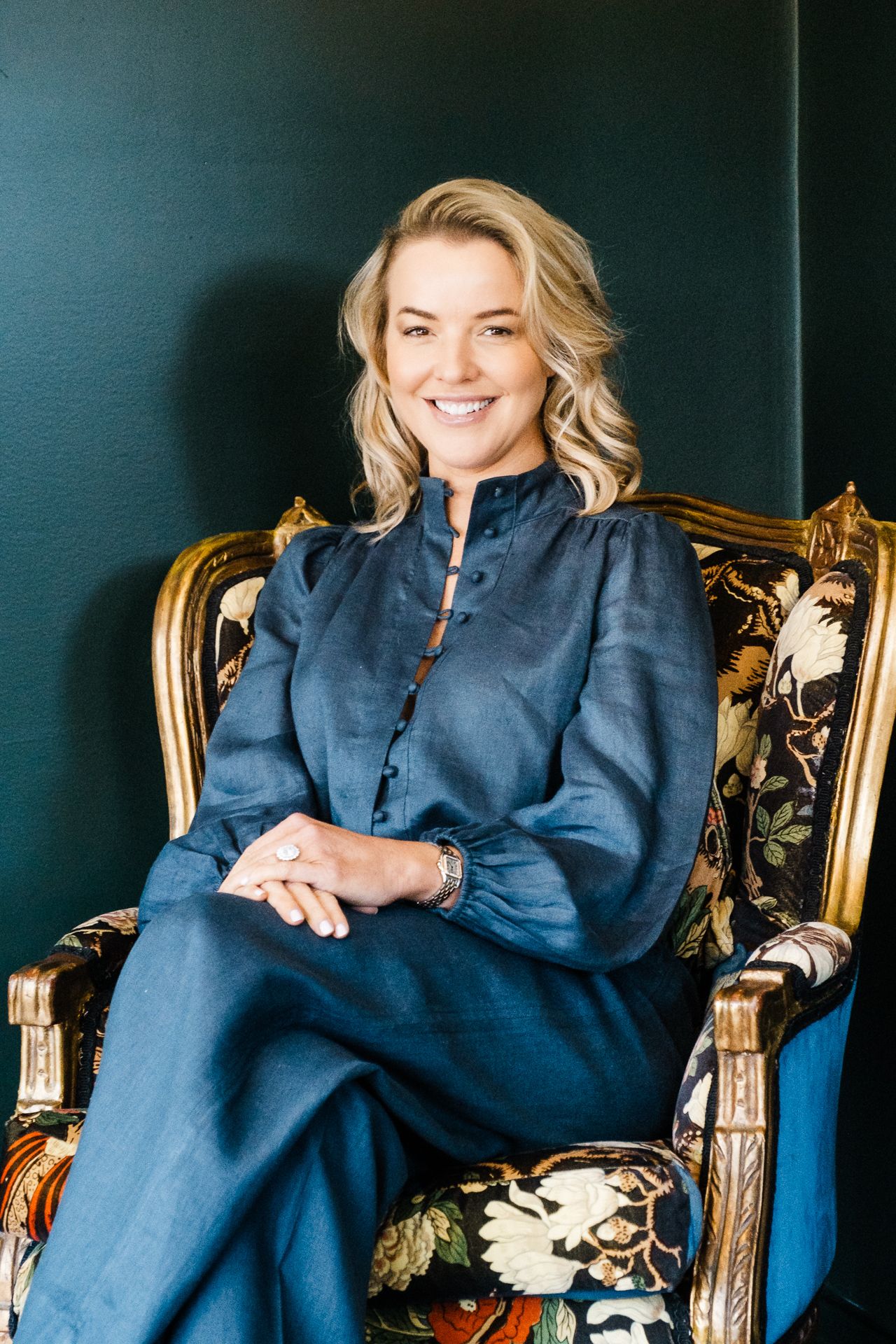 Elegant portrait series in navy blue outfit against dark background with gold accents.