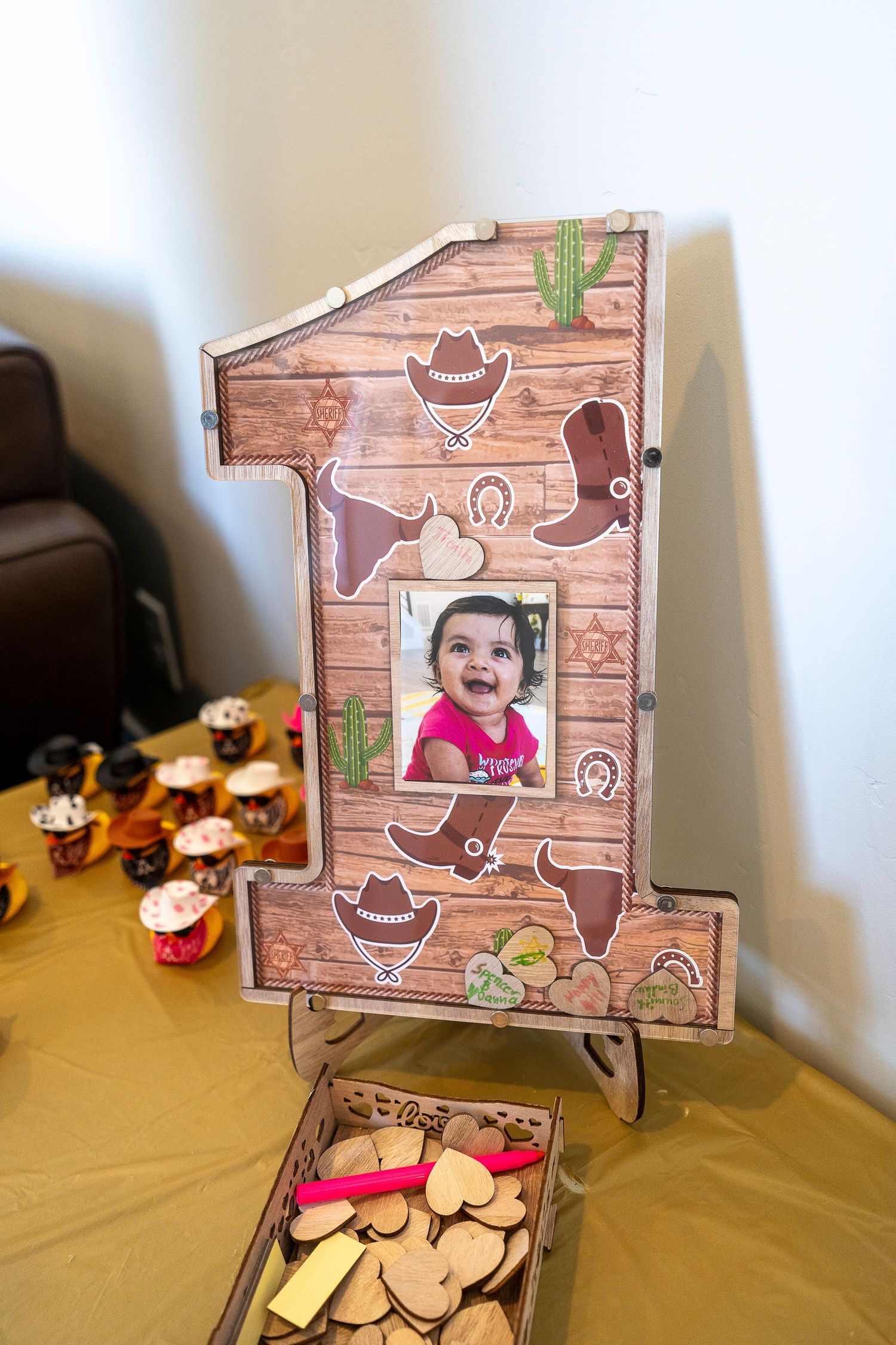 Wooden number one photo frame with western cowboy themed decorations.
