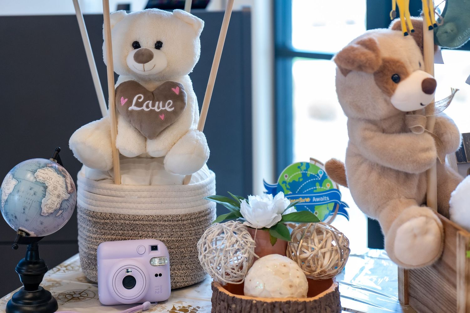 Teddy bear themed party decoration with plush toys, globe, and party accessories.