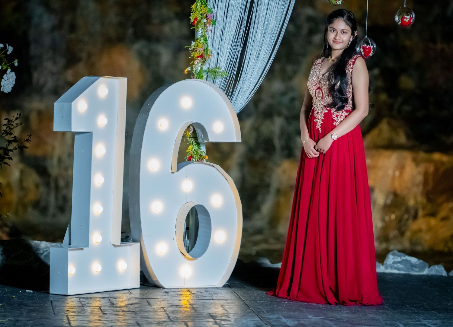 Large illuminated number '16' display with decorative lighting and backdrop.