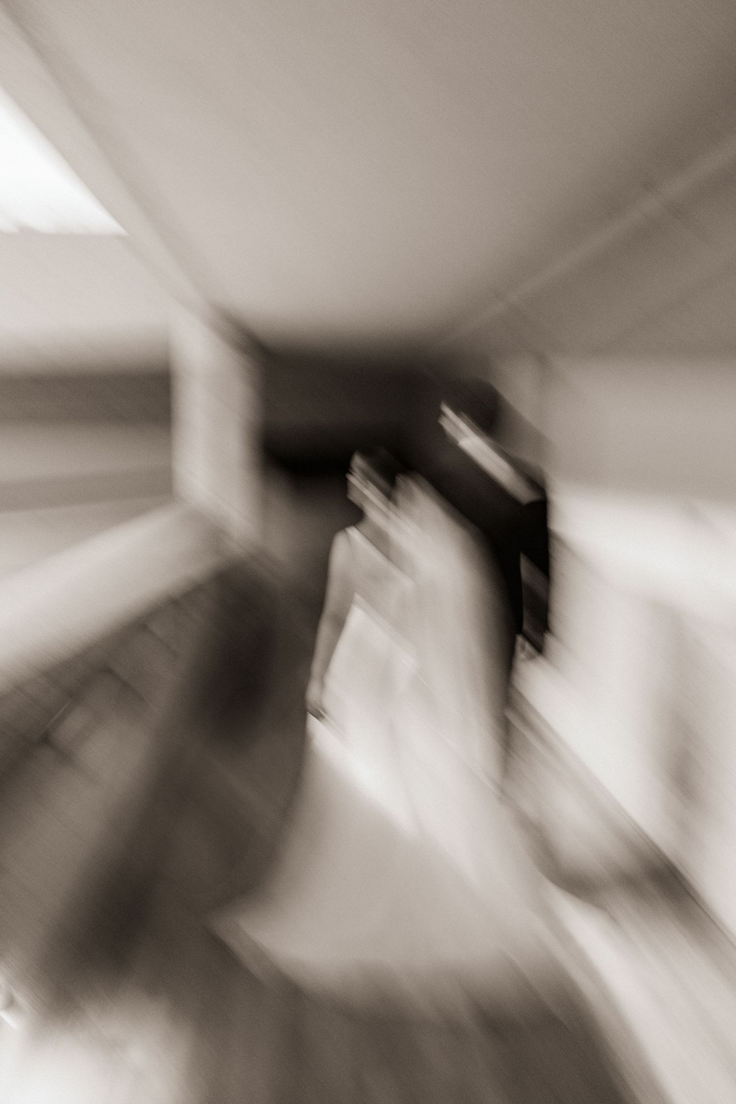 Abstract zoom blur black and white wedding photo creating dramatic motion effect with bride and groom.