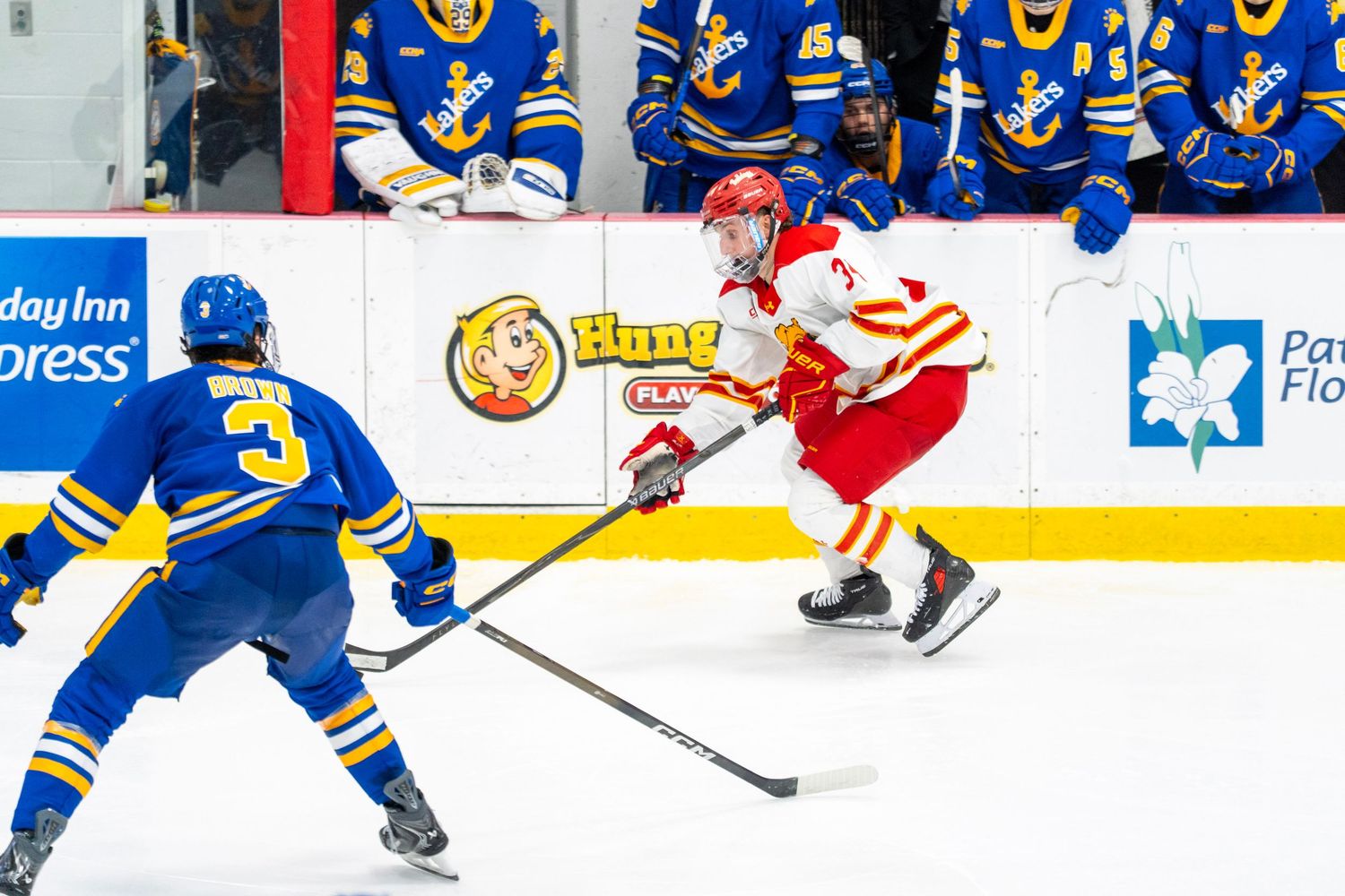 Hockey players from opposing teams battle for control of the puck during an intense NHL game.