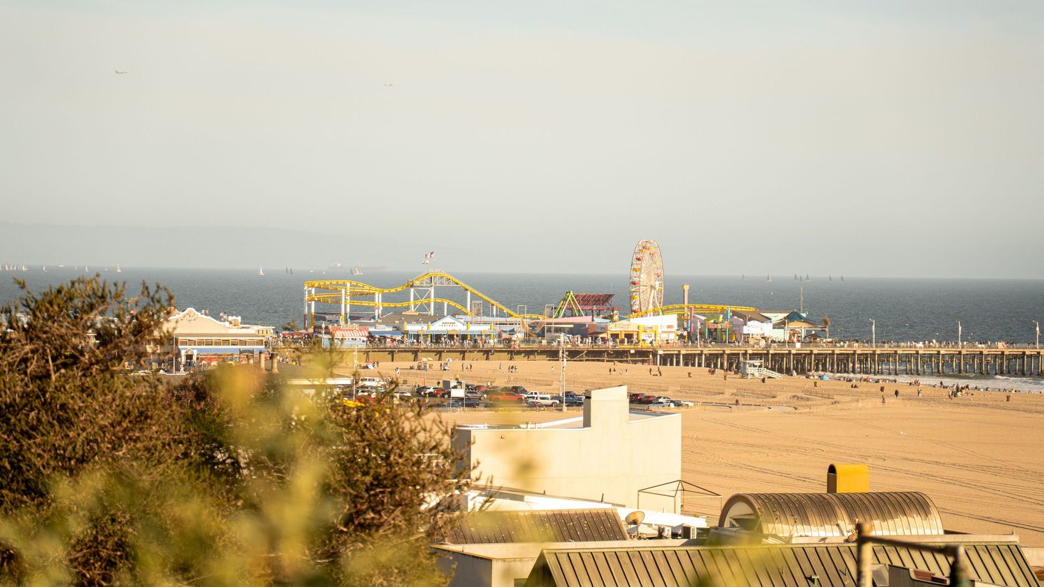 Panoramic view of Santa Monica Pier and beach buildings along the California coast.