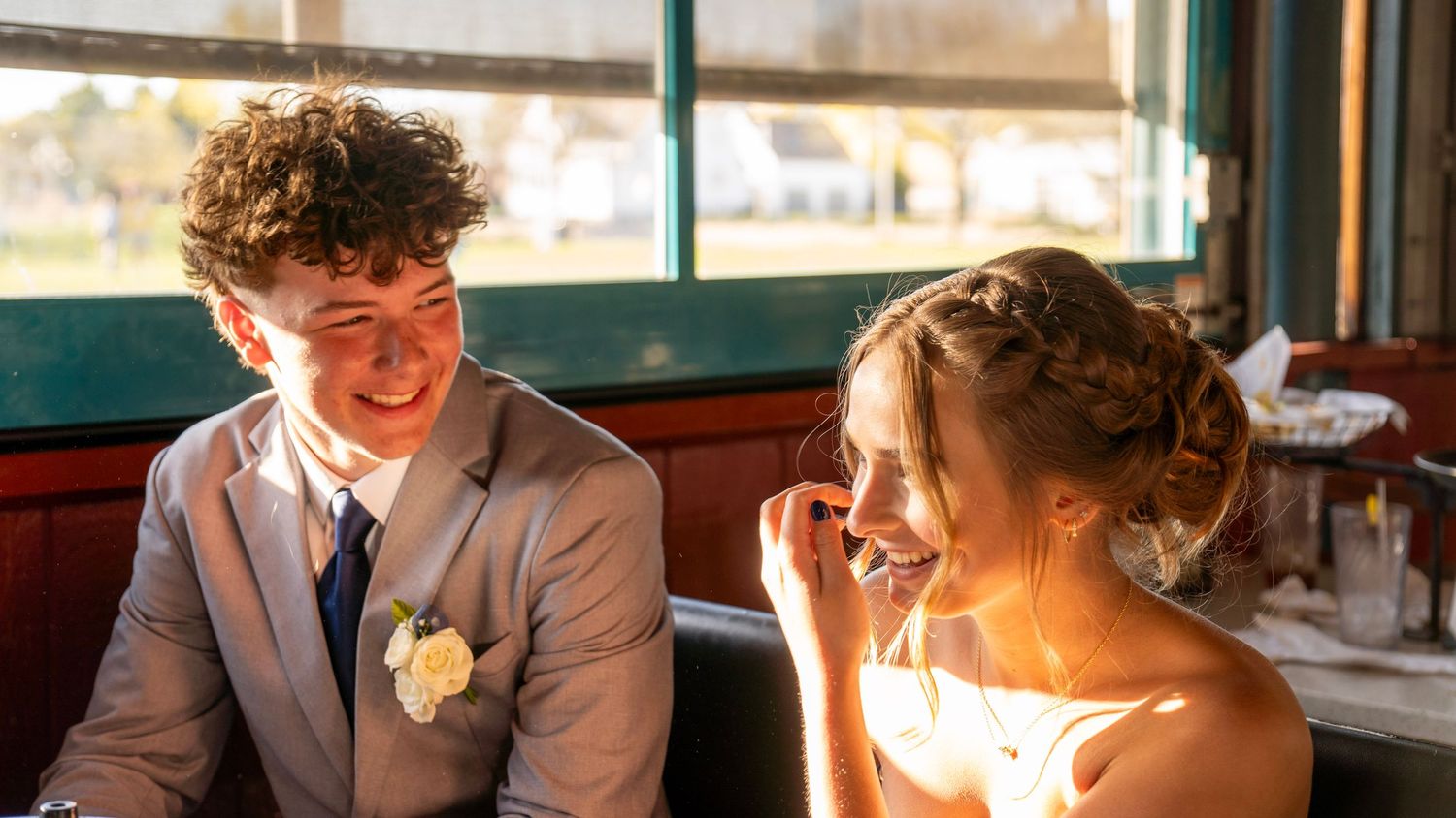 A candid photo collage capturing intimate moments of celebration and laughter at a festive restaurant gathering.