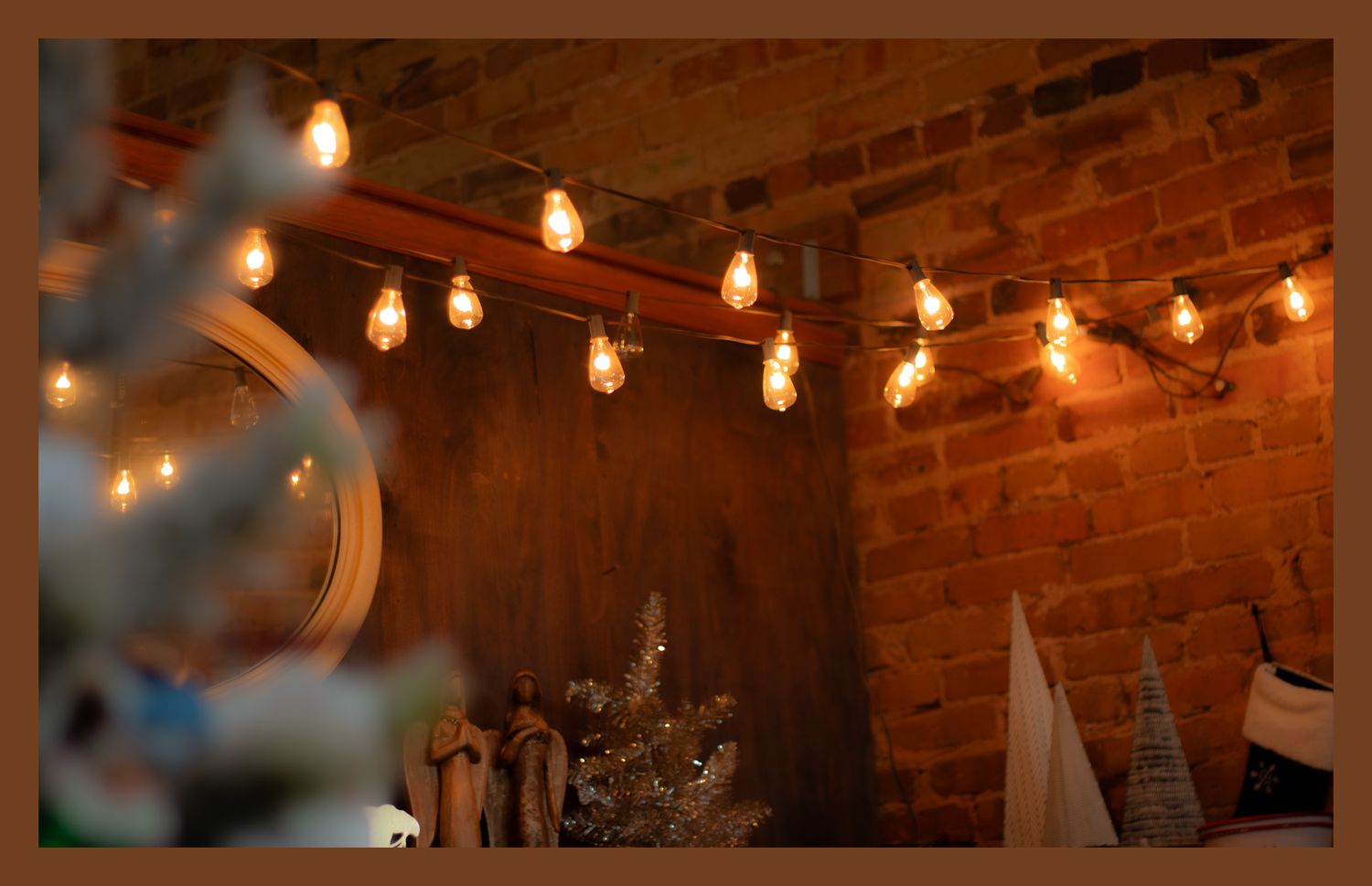 Rustic brick wall interior with string lights creating cozy ambient lighting.