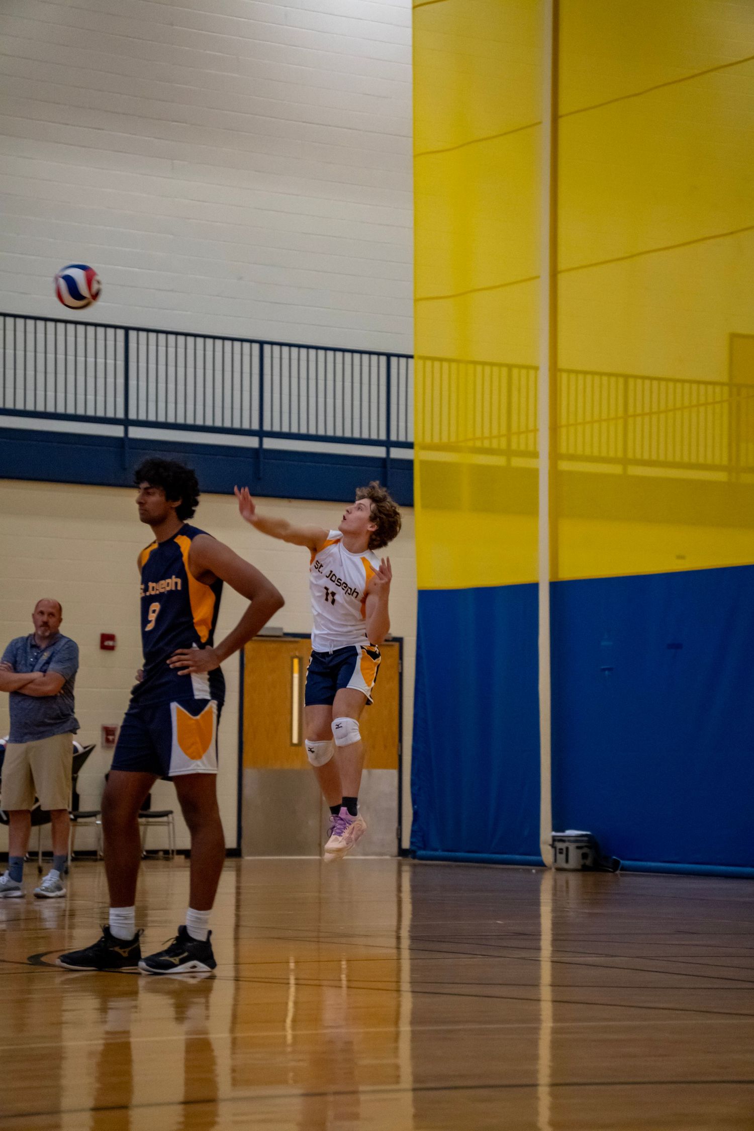Two opposing players compete for the ball during a volleyball match.