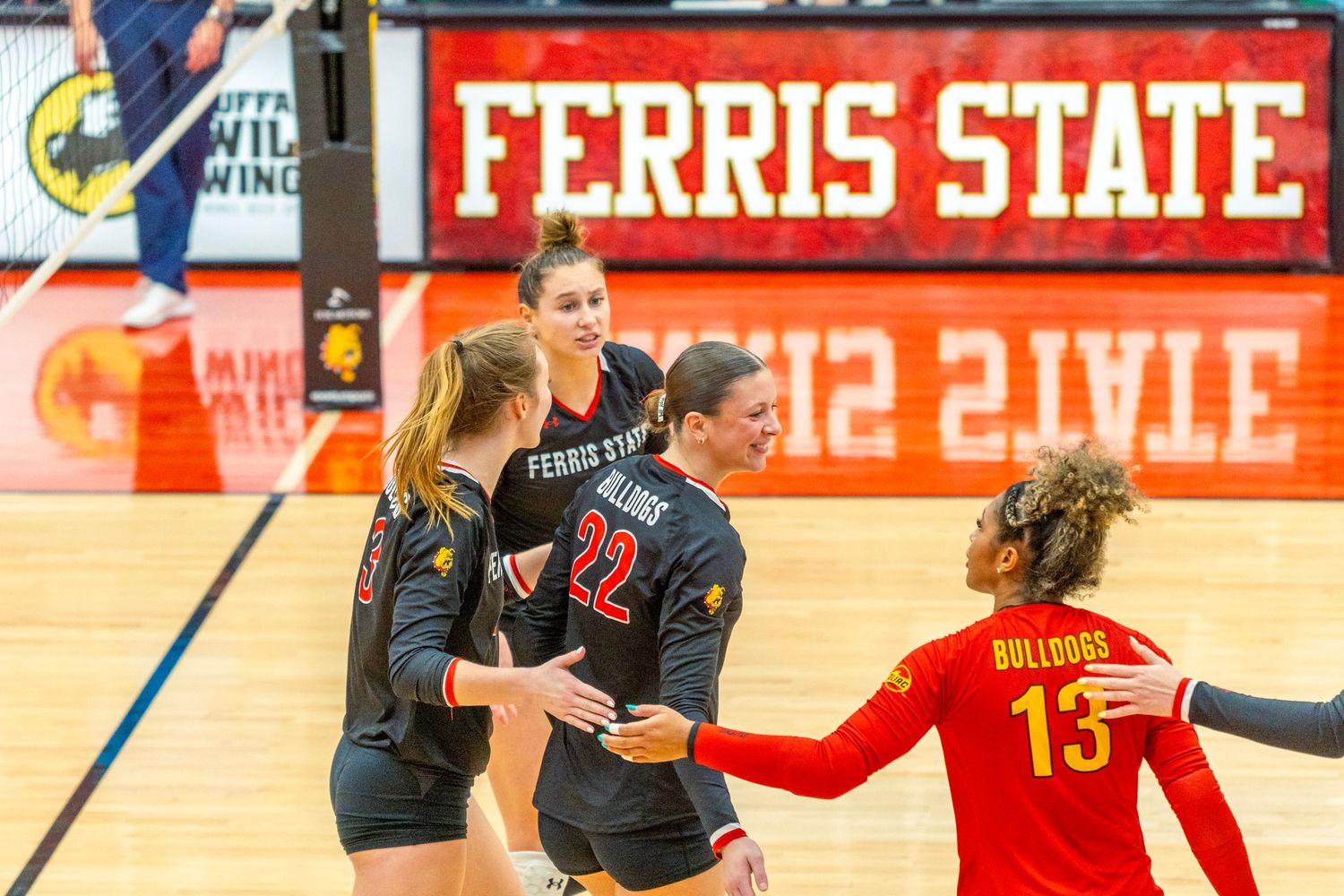 Basketball players compete for possession during an intense game at Ferris State University.