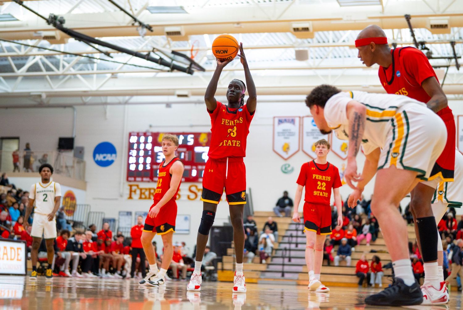 Basketball players compete in an intense indoor game with multiple action shots showing dribbling and defensive plays.