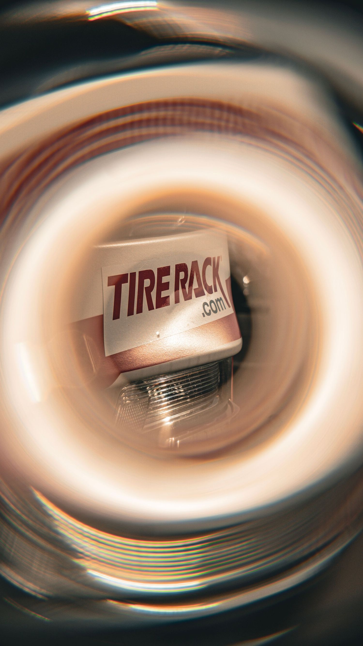 Abstract spiral effect photo of Tire Rack logo on vehicle exterior.