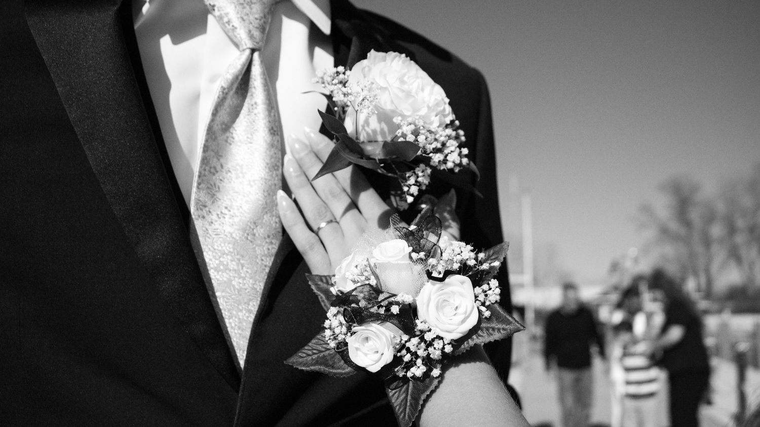 Black and white close-up photos of bridal bouquets with white flowers and greenery.