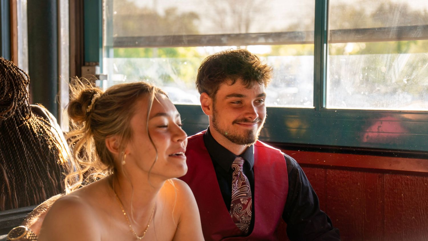 A row of small square images showing people sitting together on a train or bus interior.