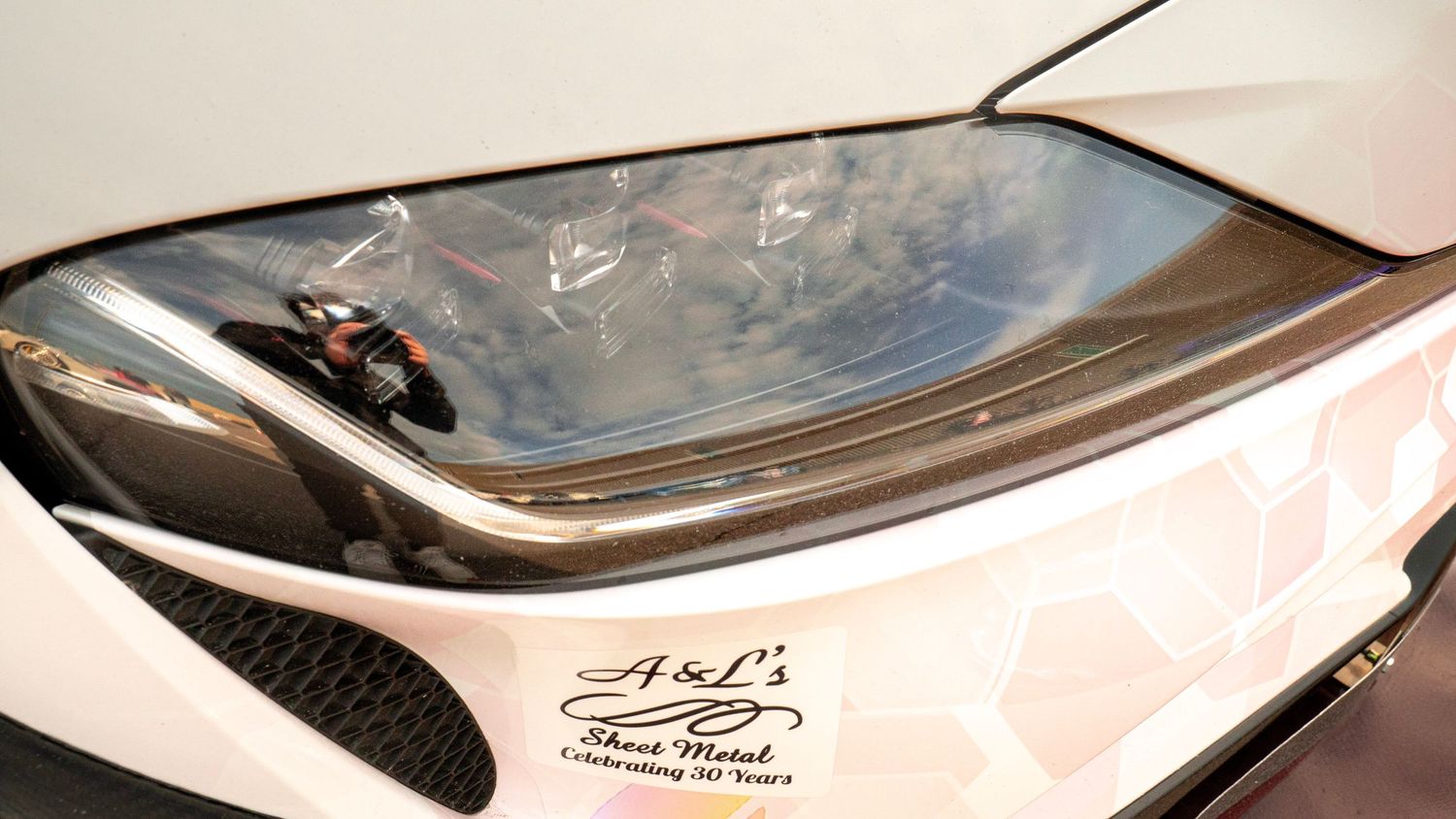 Abstract detail shots highlighting curves and contours of sports car bodywork.