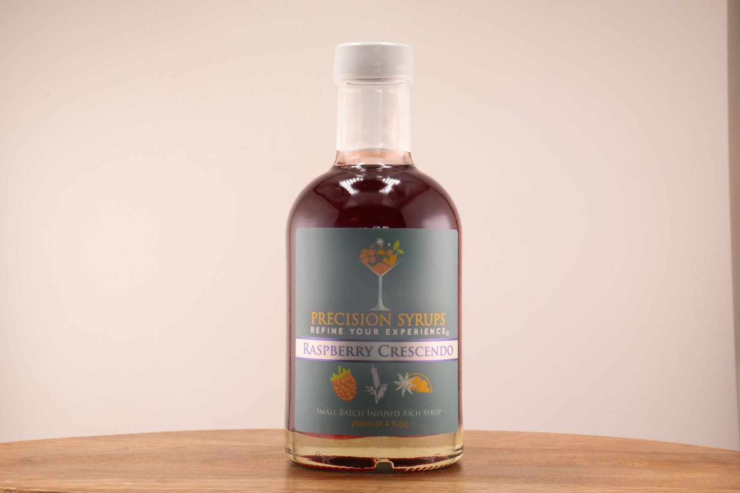 Dark reddish-brown liquor bottle with distinctive tree emblem label displayed on wood table.