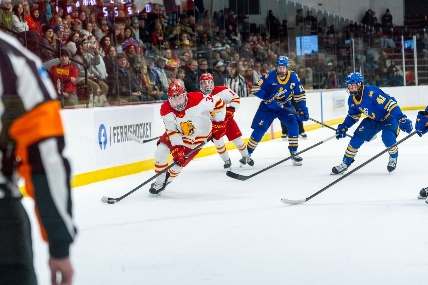 Hockey players compete for the puck during an intense professional game on ice.