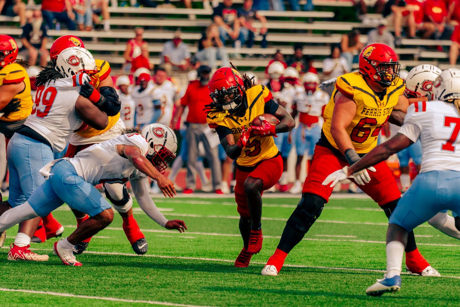 Football players from opposing teams line up at the line of scrimmage during an intense game.