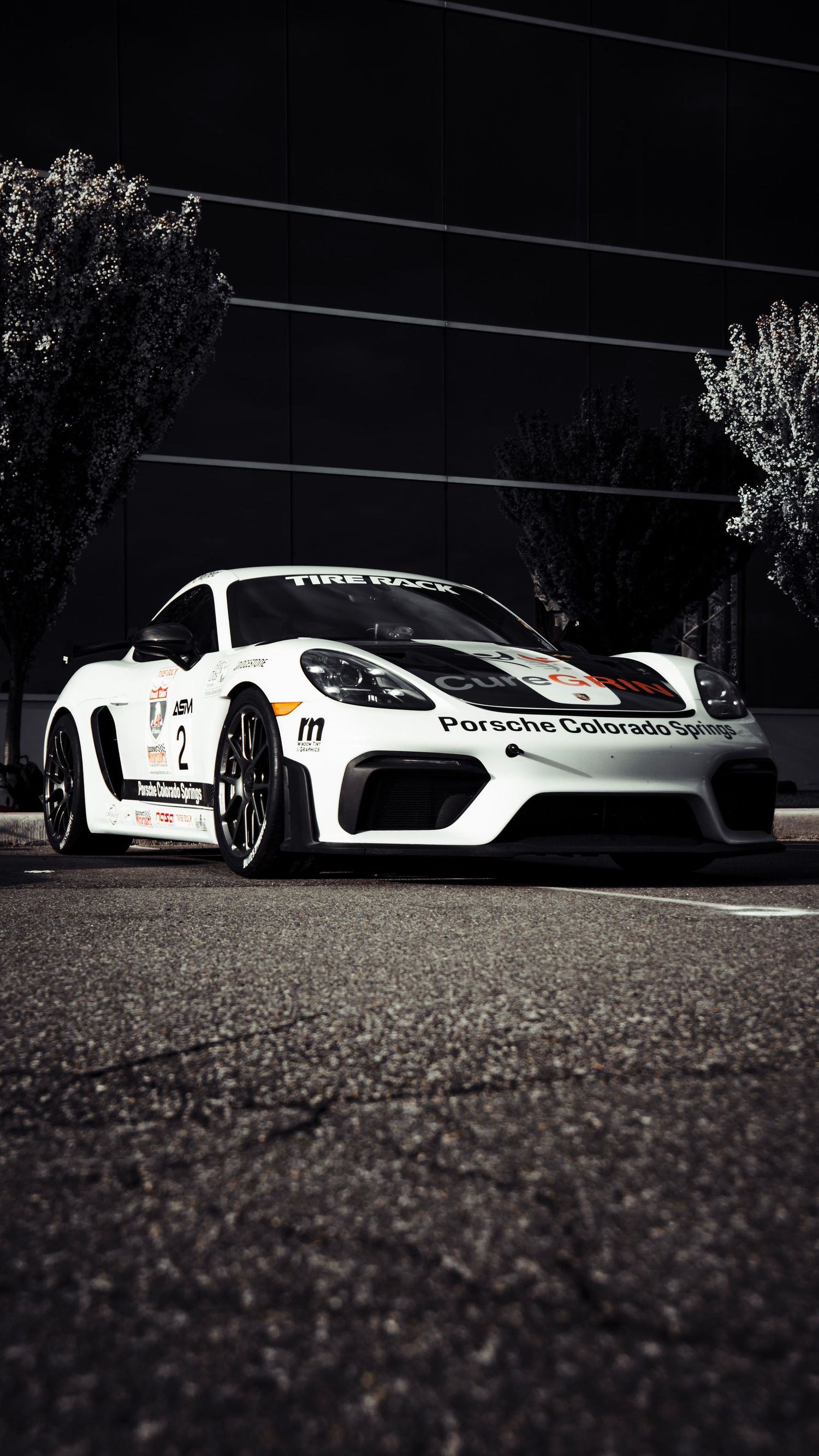 White Porsche race cars arranged in dramatic low angle composition.