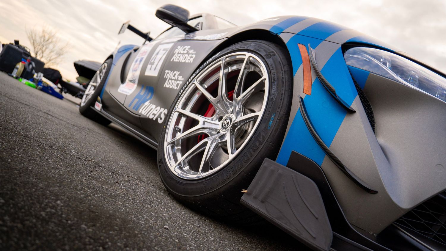 Low angle view of a modified Toyota Supra race car with blue and black livery.
