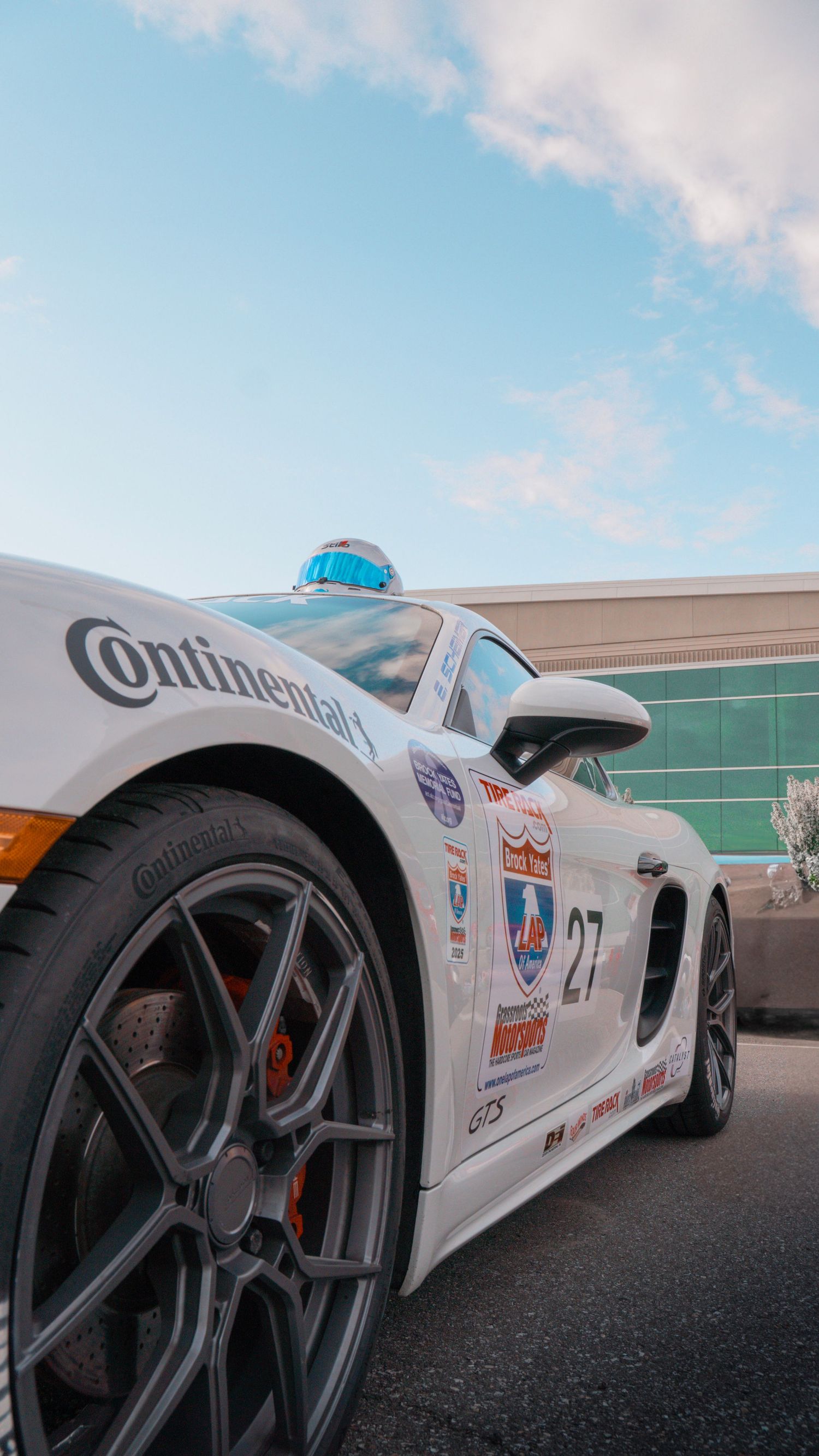 Racing car with number 97 displaying various sponsor decals and distinctive black wheels.
