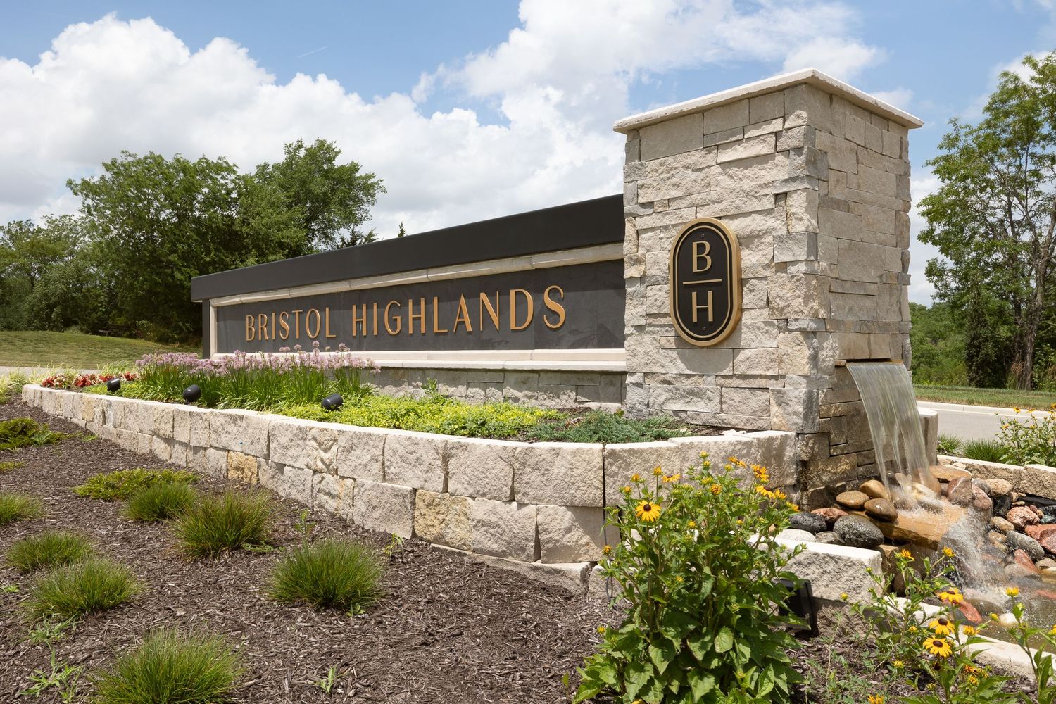 Bristol Highlands entry with waterfall. Photo produced by Derek Mecca in Johnson County KS. Photography for luxury real estate.