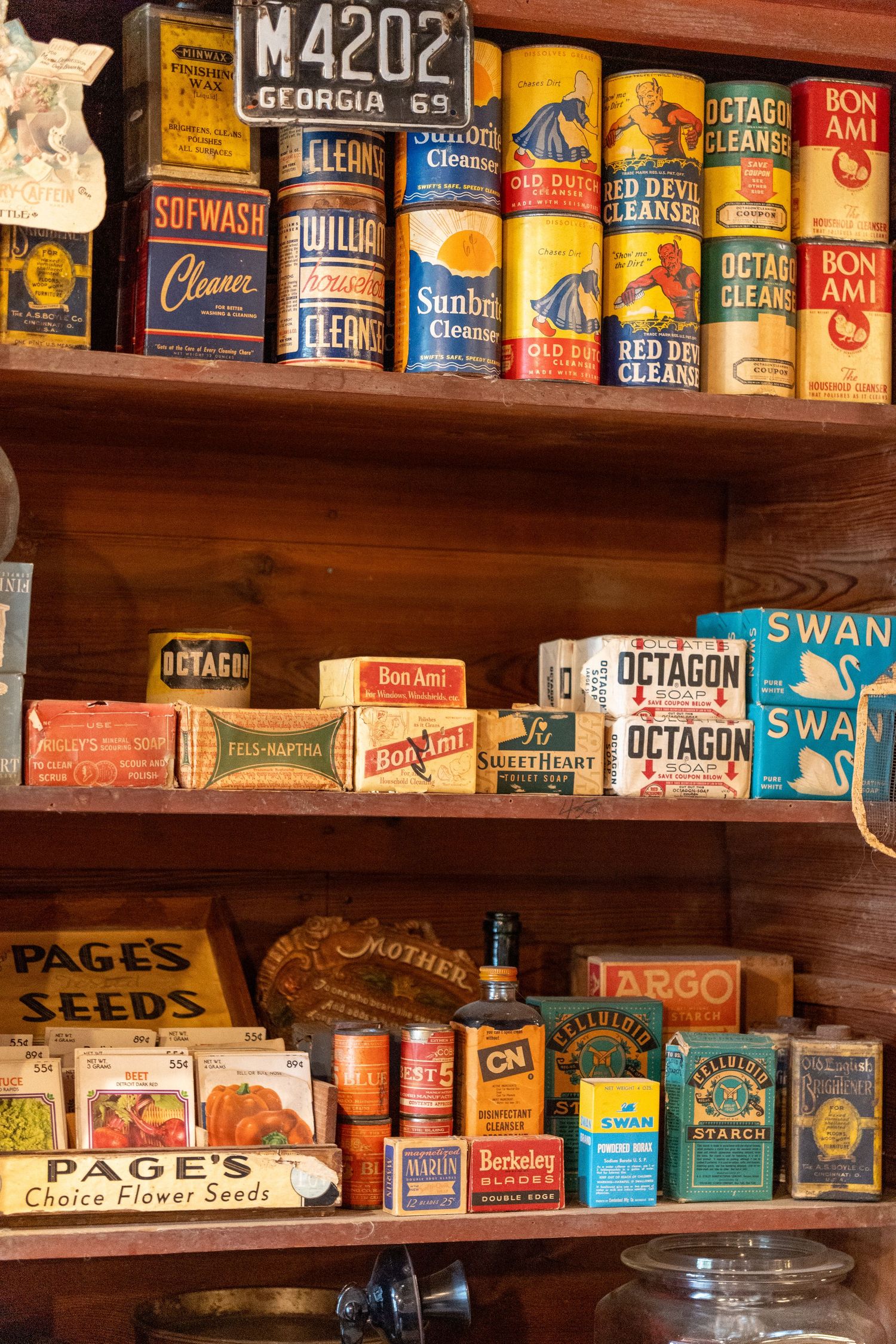 Shelves filled with vintage, nostalgic, grocery items and tins, including old soap boxes, spice containers, and glass jars