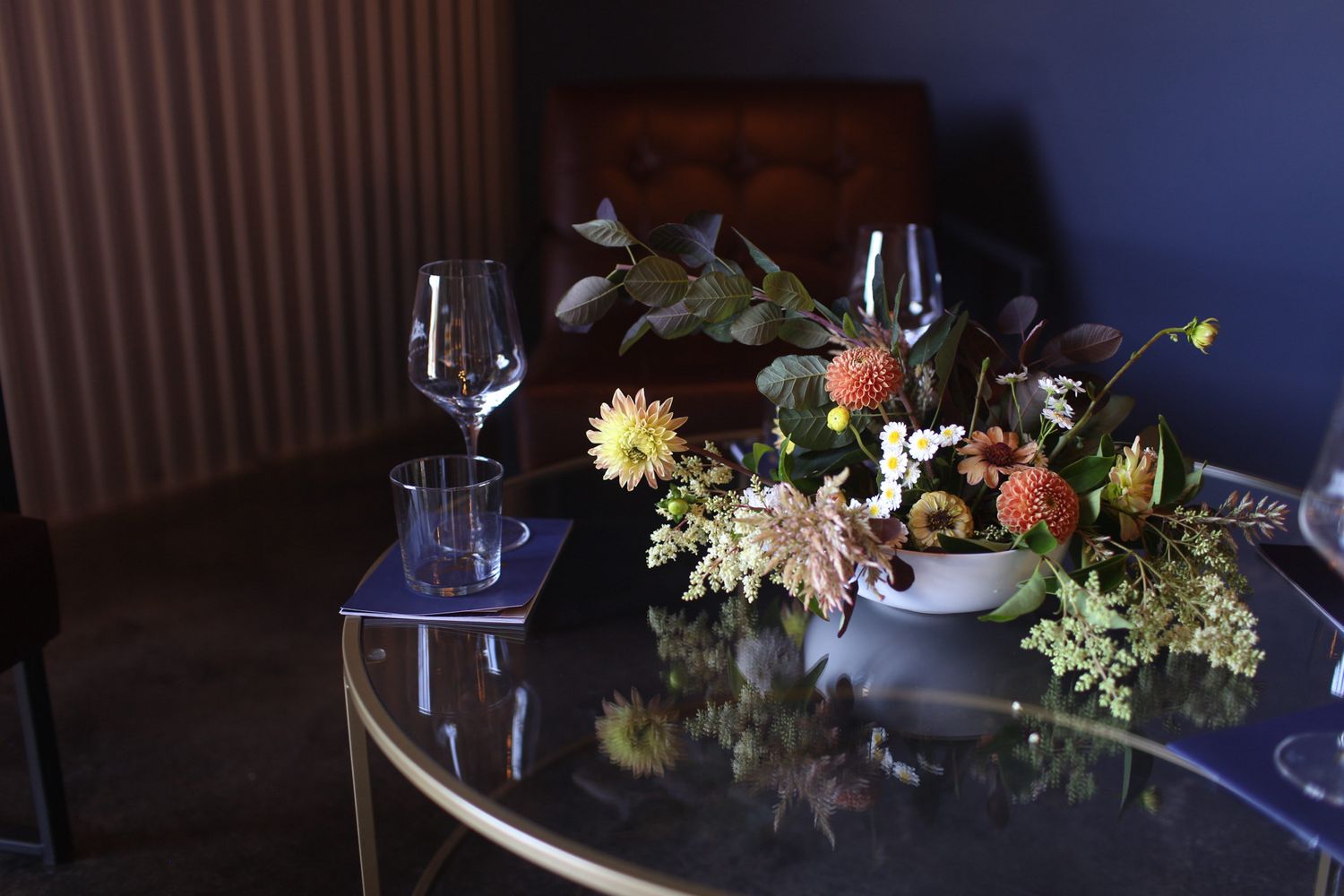 mid-sized colorful, cheerful arrangement on a table with wine glasses in a wine tasting room / winery in Tin City, Paso Robles, California