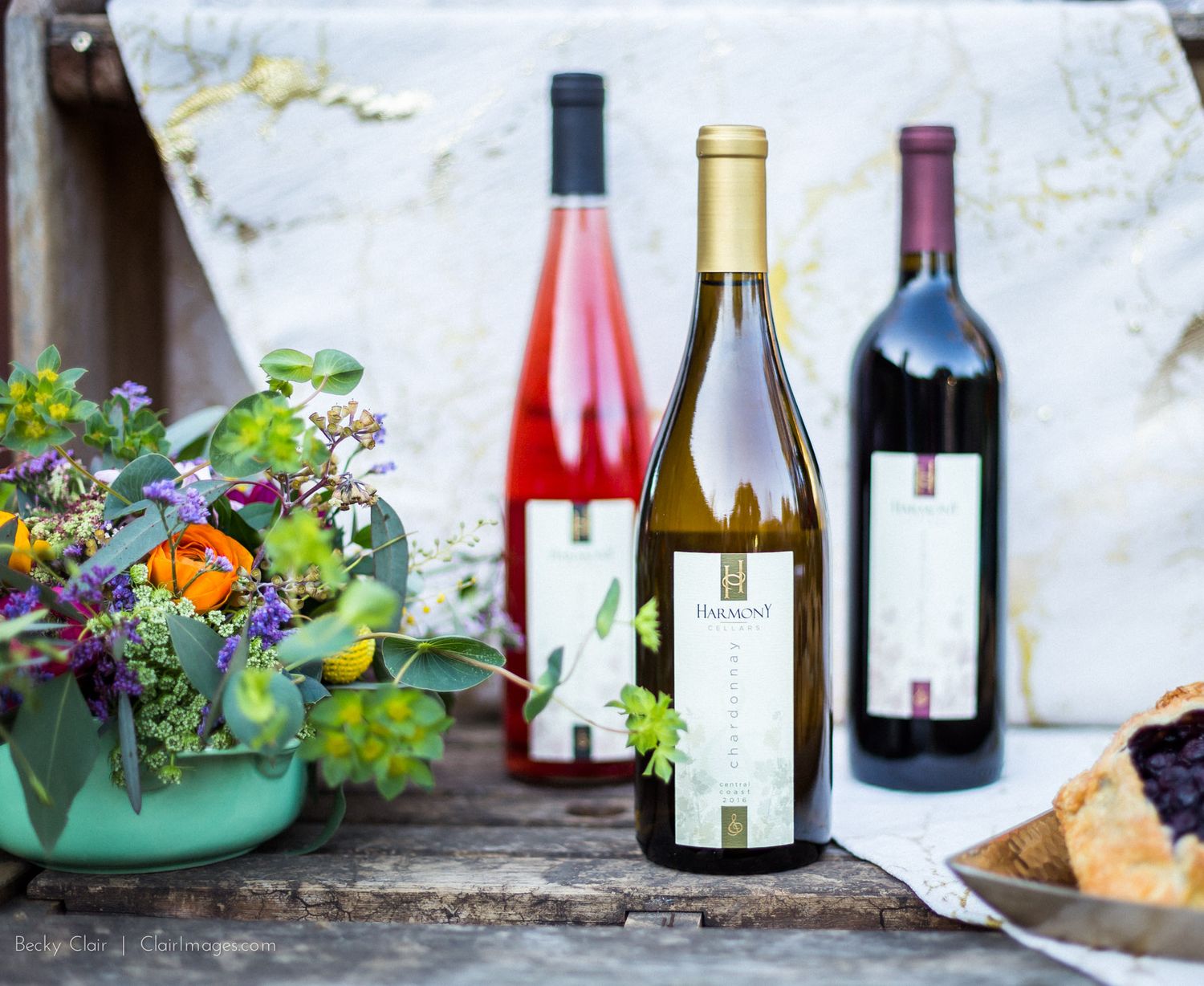 textured, colorful, feathery flower arrangement next to bottles of SLO county local wine - Cambria, California, San Luis Obispo County