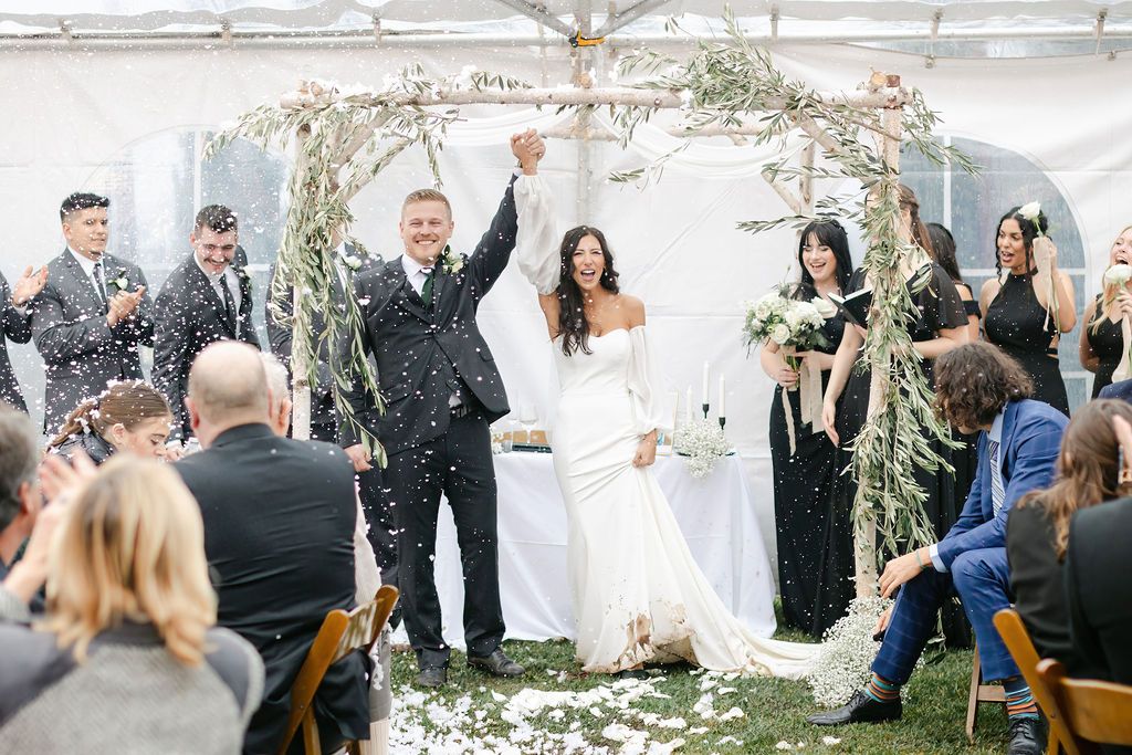 Wedding floral arch in Santa Margarita, San Luis Obispo County, California. Bride and groom wedding celebration.