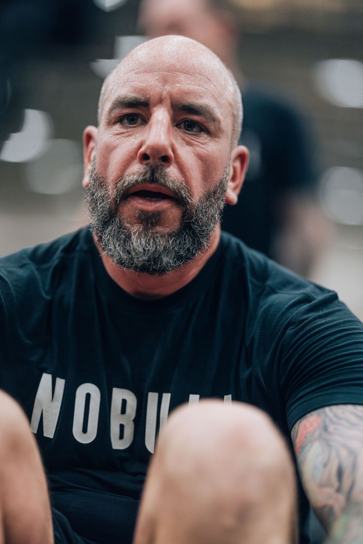 Athlete in black workout gear showing intensity during training session.