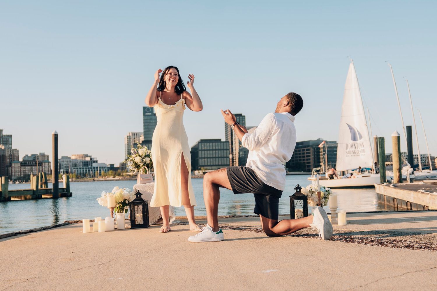 A series of connected beach wedding photos showing white decor and ceremony setup along a waterfront dock.